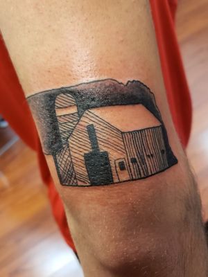 An outline of a state and a barn 