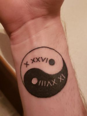 Yin yang tattoo with my parents birthdays in roman numerals 
