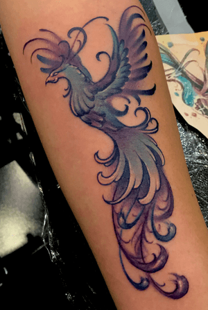 Phoenix forearm tattoo with that swirly action...