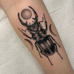 Stag beetle with triple goddess symbol.