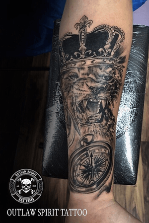 Lion with crown and compas tattoo