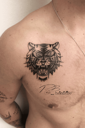 Blackwork tiger tattoo on chest by Patrick Bates, featuring intricate illustrative style.