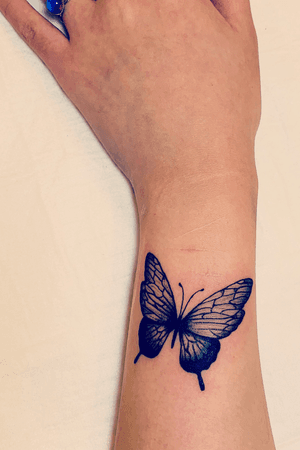 woman wrist butterfly tattoo