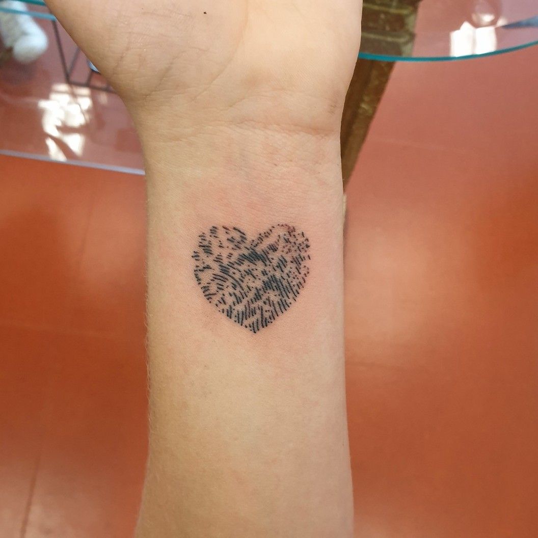 Small elephantfingerprint tattoo on the right forearm