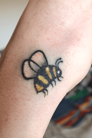 Bee tattooed on hand 