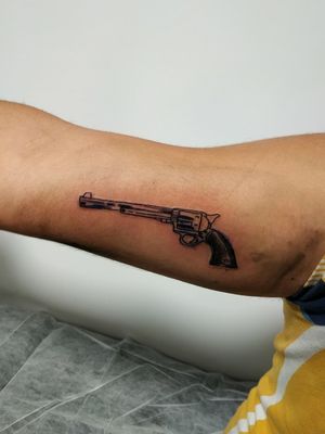 Small revolver on the inside of the arm 