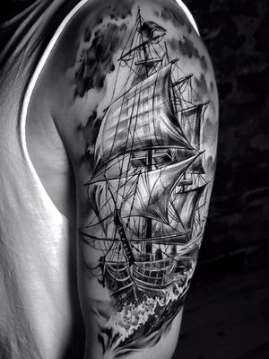 realism ship tattoo on upper sleeve