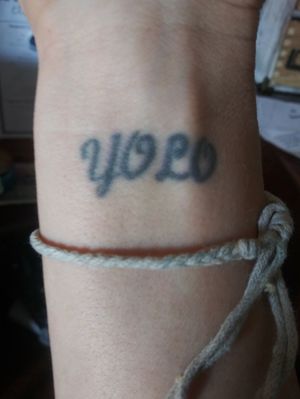 This tattoo was done in 2004 after my best friend was killed in a car accident. A group of 24 girls did it to remeber her as her daily quote in life was " you only live once"
