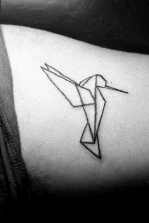Geometric contour line drawing of a hummingbird medium size on the inner arm.