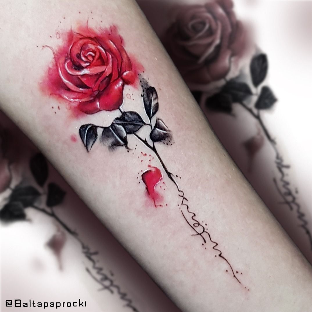 Watercolor red rose tattoo on the bicep