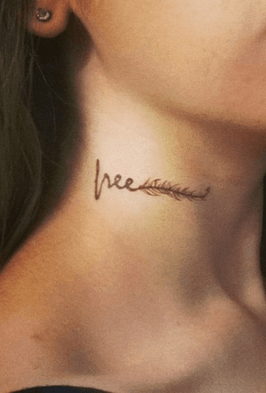 Script “Free” with line drawing of a feather on side of neck in black.
