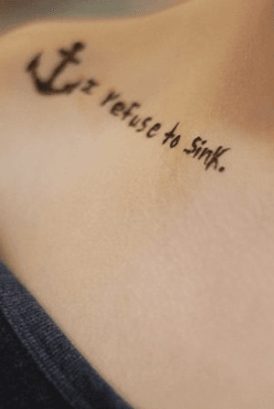 Silhouette of a classic anchor with “I refuse to sink.” in printed font following the underside of the collar bone on a female client.