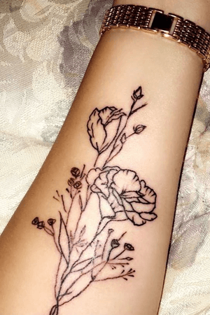 Contour line drawing flowers on female forearm from clients own artwork.