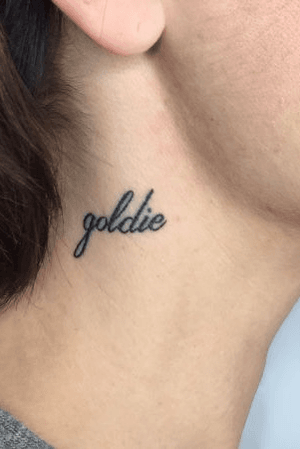 Classic script small size on neck of nickname Goldie on female. 