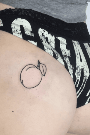 Black outline of a peach on clients butt cheek.