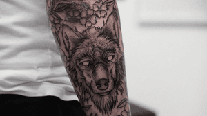 Rugged wolf done alone with small floral fillers 