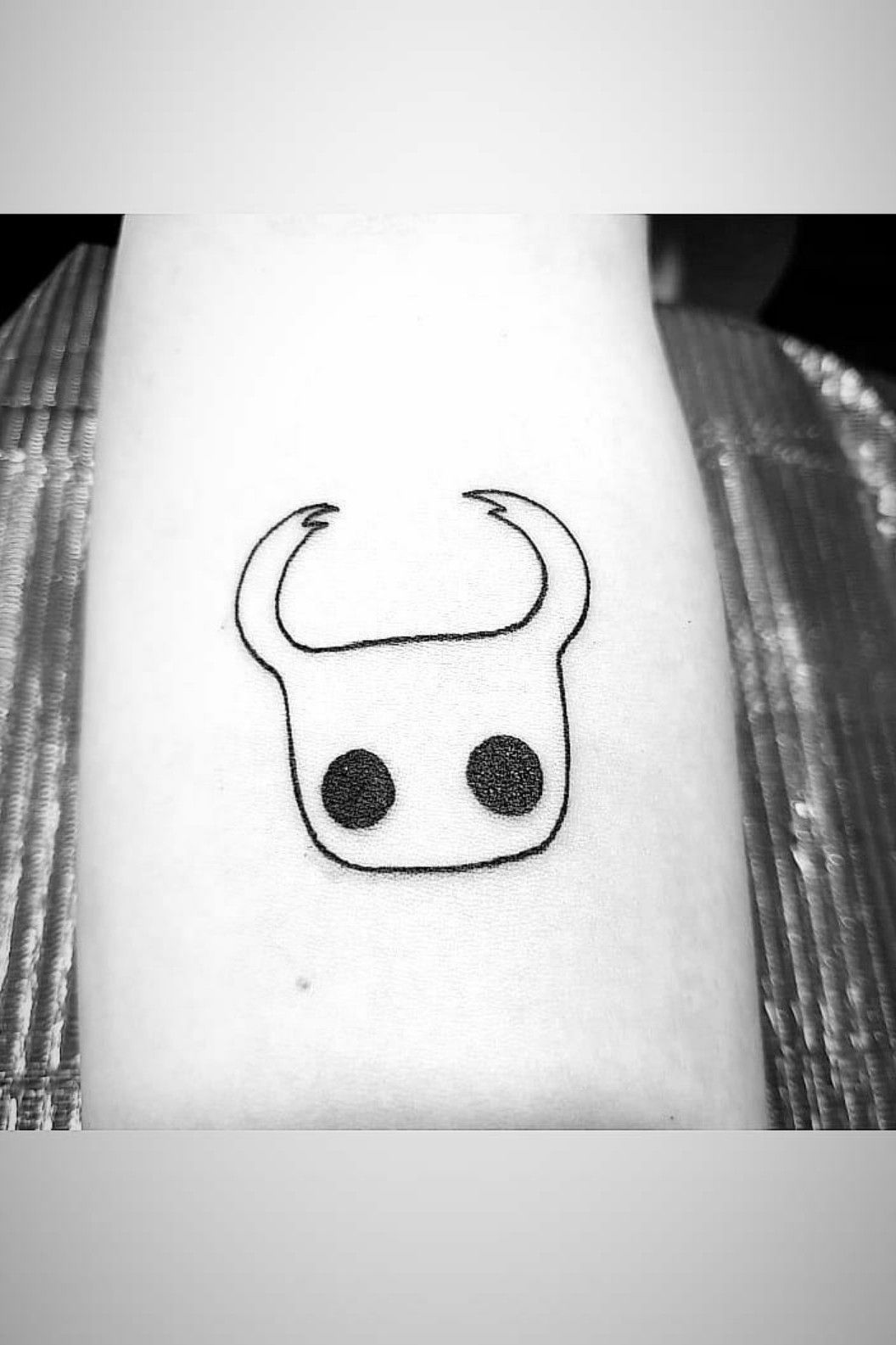 Hollow Knight tattoo located on the upper arm