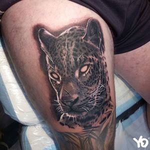 Black and grey super realistic Leopard tattoo. 