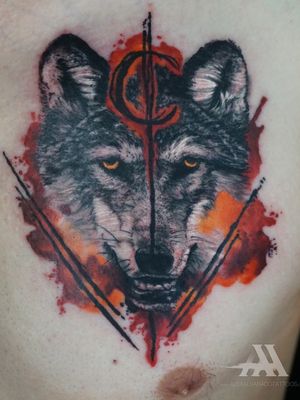 Get mesmerized by this stunning wolf tattoo on your arm, beautifully done in watercolor style by the talented artist Alex Santo.