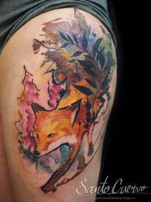 Vibrant watercolor tattoo of a fox and leaf on upper leg by talented artist Alex Santo. A unique and beautiful design.