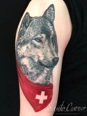 Experience the wild beauty with this stunning black and gray wolf tattoo by Alex Santo.
