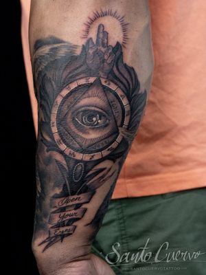 Get mesmerized by this mystical black and gray forearm tattoo of a hand and the all seeing eye, done by the talented artist Alex Santo.
