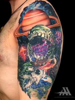 Discover the unknown with this vibrant watercolor tattoo featuring a galaxy, planet, and astronaut on the upper arm. Reach for the stars with this unique piece by talented artist Alex Santo.