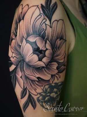 Elegant black and gray peony flower tattoo by Alex Santo, showcasing intricate fine line work on upper arm.