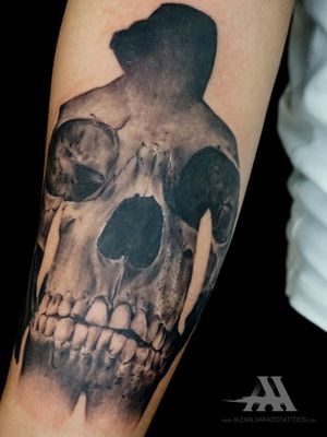Get mesmerized by Alex Santo's stunning realism and surrealism tattoo featuring a skull on your forearm.