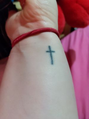 simple cross wrist tattoo