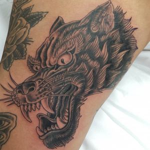 One shot black and grey wolf head on the inside thigh 
