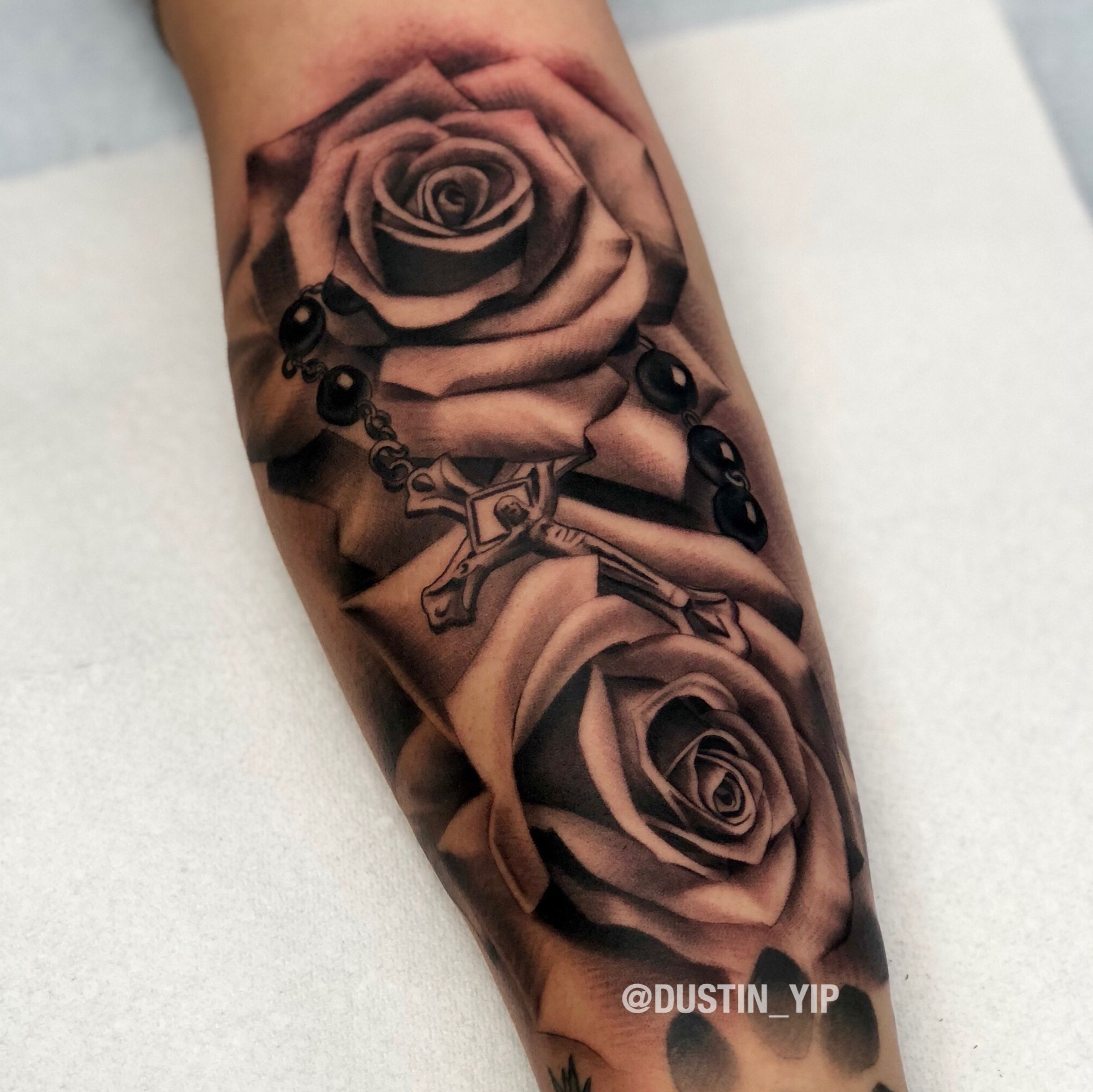 Tattoo uploaded by Dustin Yip • Roses and a rosary on the inner forearm