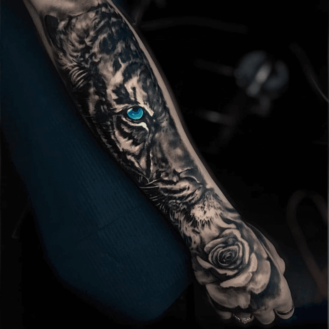 Realistic black and gray tiger piece with blue eyes by Haylo TattooNOW