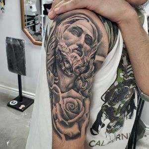 Fully healed jesus statue with rose tattoo..Black and grey custom design.