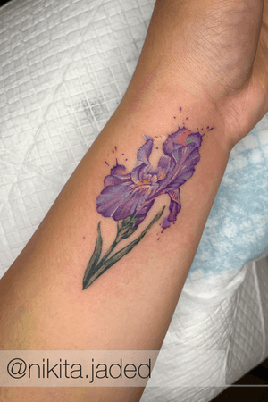 Get a stunning illustrative watercolor flower tattoo on your forearm by Nikita Jade Morgan. Stand out with this unique and colorful design!