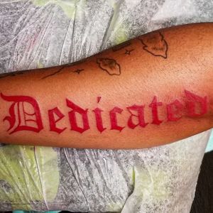 Dedicated old english tattoo in red 