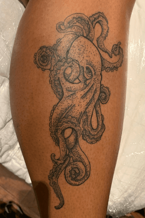 black dot style octopus leg tattoo 