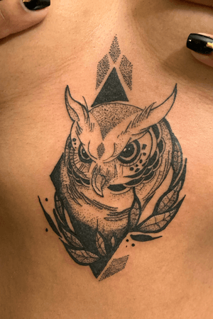 another black and dots owl tattoo sternum 