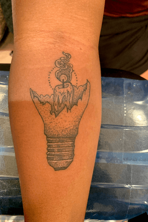 black and grey dot style broken lightbulb and candle tattoo 