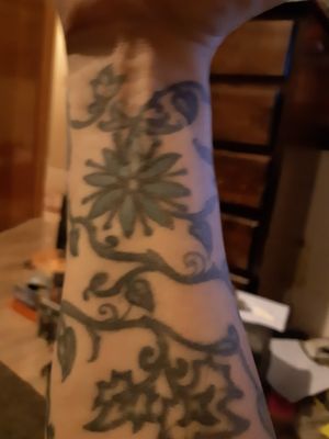 The tattoo needed new lining and I had it reclined and had the color cyan put in one flower. First tattoo was done by Natt, a bff in Montreal,  then 20 years later the fall. Love it Side 1