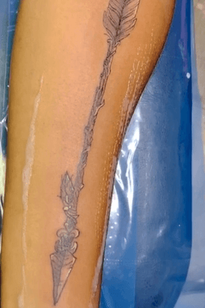 black and grey arrow arm tattoo 