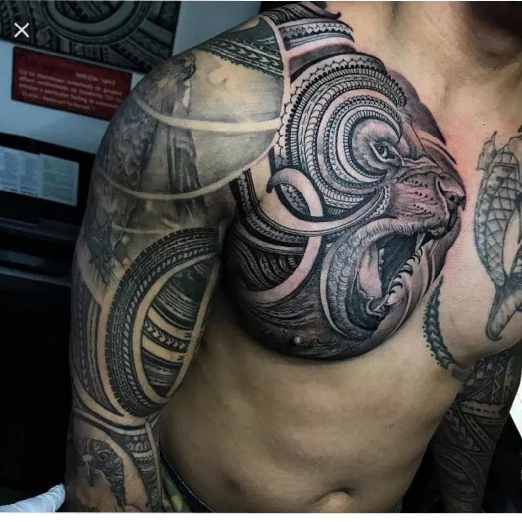 Tribal Lion Face Tattoo On Arm And Chest