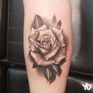 Black and grey realistic tattoo rose.