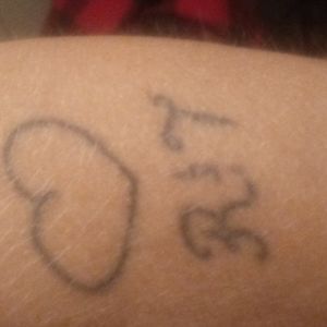 My only jailhouse tat for the only time I have been in jail I was going to get it color rainbow for gay pride but that is my daughter and now ex wife initial but I do have another daughter and her name starts with A so I didn't know what to do with the T and how easy it is to be changed to an A so any suggestions on what to do with im