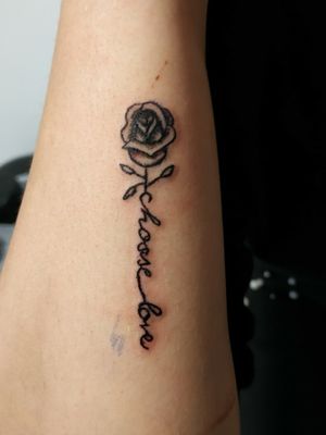 Simple little rose with writing tattoo on arm