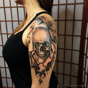 Skull, lilies, filigree and beads. Black and grey upper arm and shoulder tattoo. #blackandgrey #skull #filigree #shoulder #lilies #feminine #realism #ornamental #custom #chicano 