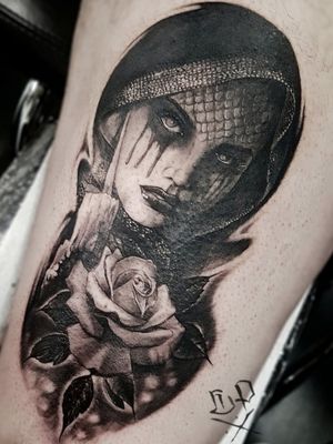 Detailed blackwork tattoo on lower leg featuring a realistic flower and woman by Mauro Imperatori.