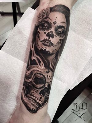 Experience the artistry of Mauro Imperatori with this stunning blackwork tattoo featuring a catrina and skull motif on your forearm.