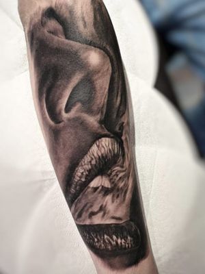 Beautiful black and gray forearm tattoo of a woman surrounded by swirling smoke, done by Mauro Imperatori in a stunning realistic style.