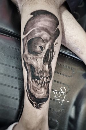 Bold blackwork skull design for lower leg placement, crafted by the talented artist Mauro Imperatori.